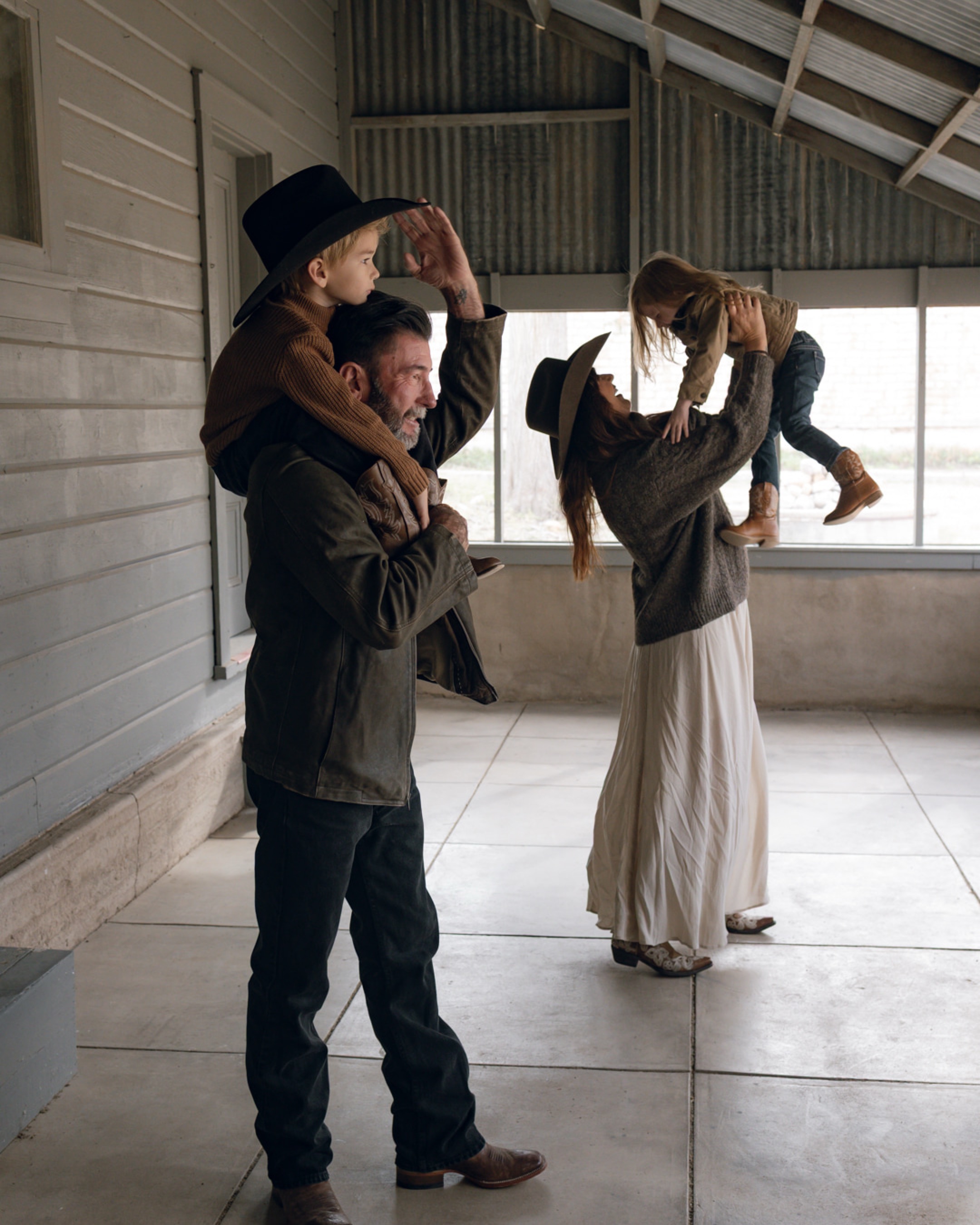 Jason and Stephanie sharing a playful moment with Hudson and KJ
